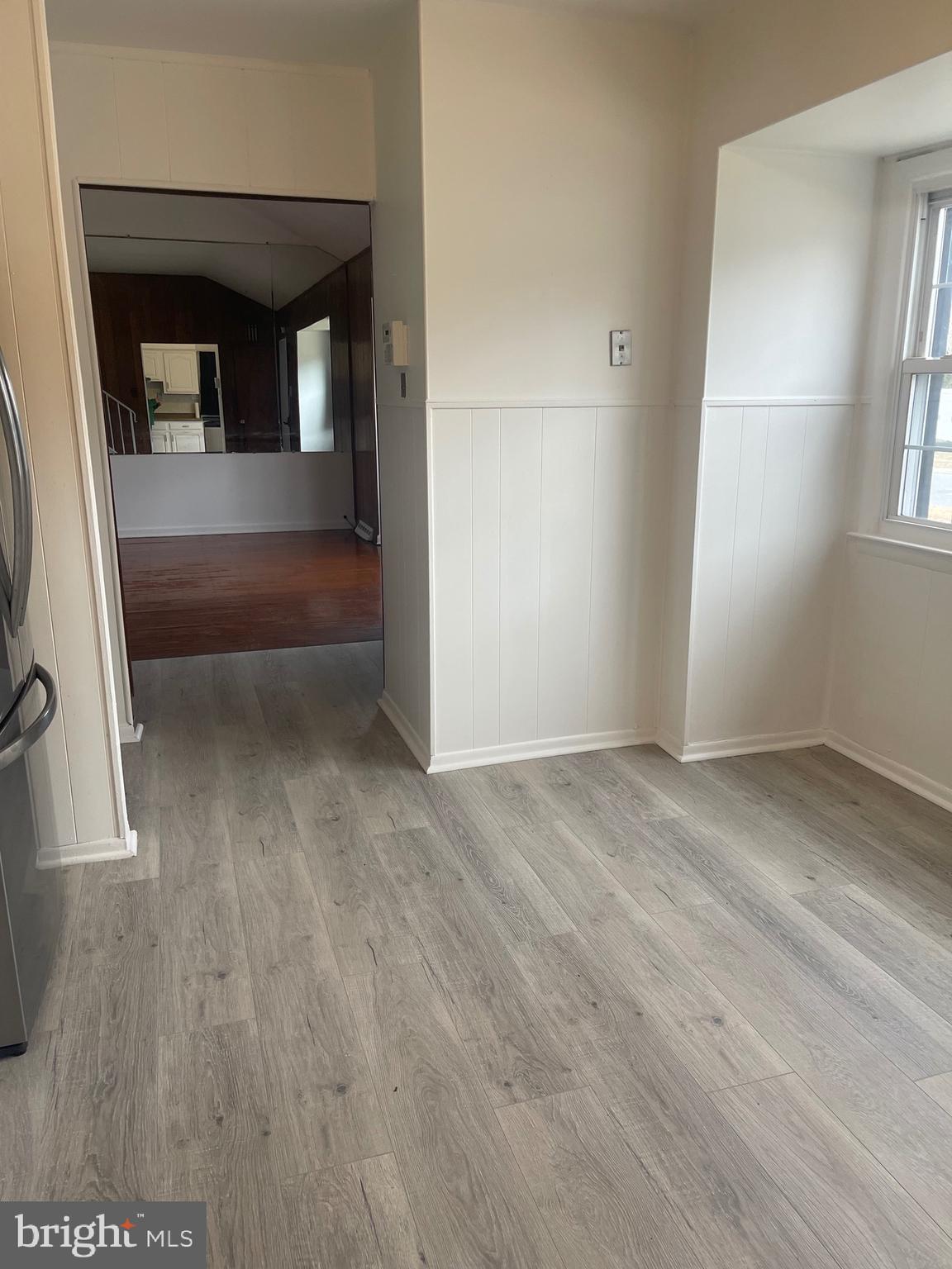 183 Lincoln Road Wenonah, NJ 08090 - Photo 3 of 19 an empty room with wooden floor and windows