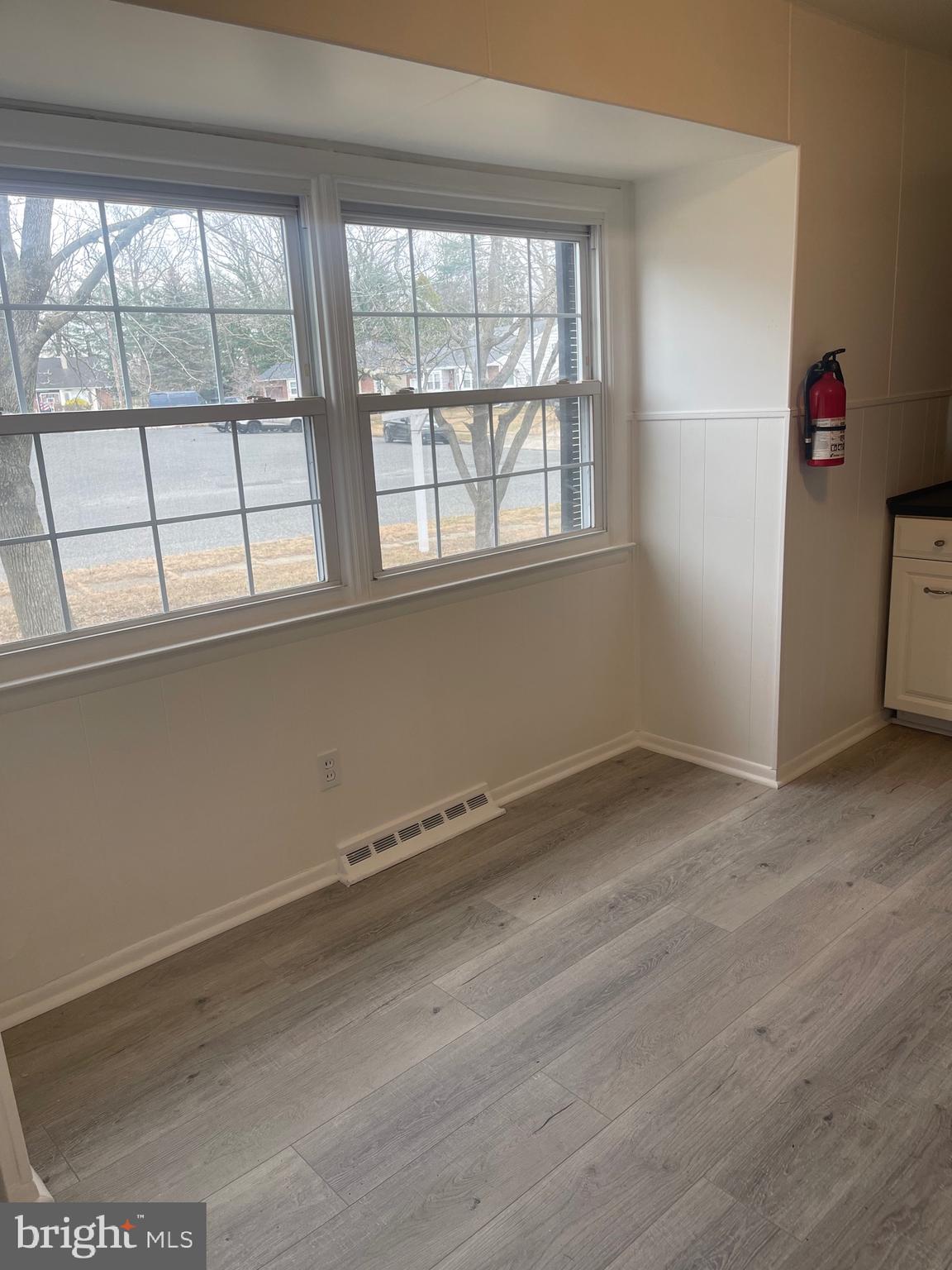 183 Lincoln Road Wenonah, NJ 08090 - Photo 6 of 19 an empty room with wooden floor and windows