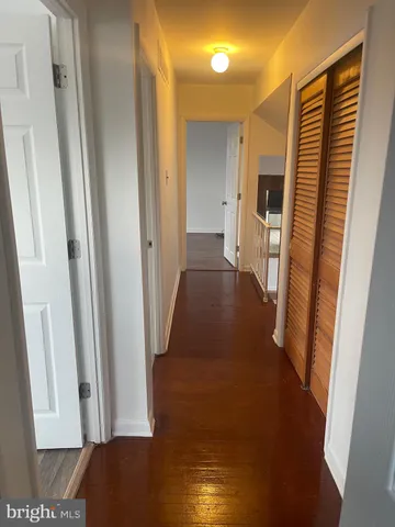 a view of a hallway with a wooden floor
