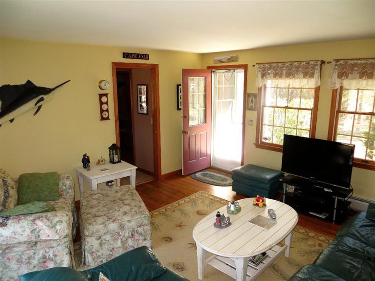 1145 Herring Brook Road Eastham, MA 02642 - Photo 3 of 34 a living room with furniture and a flat screen tv