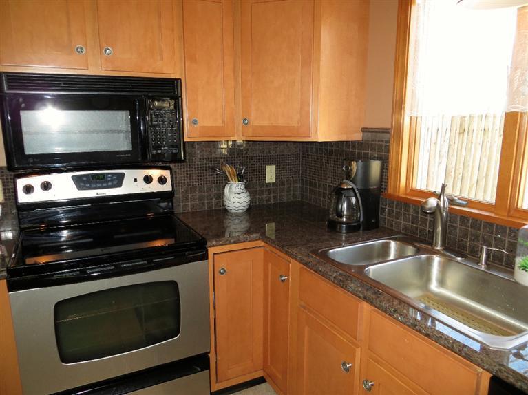 1145 Herring Brook Road Eastham, MA 02642 - Photo 6 of 34 a kitchen with granite countertop a stove and a sink
