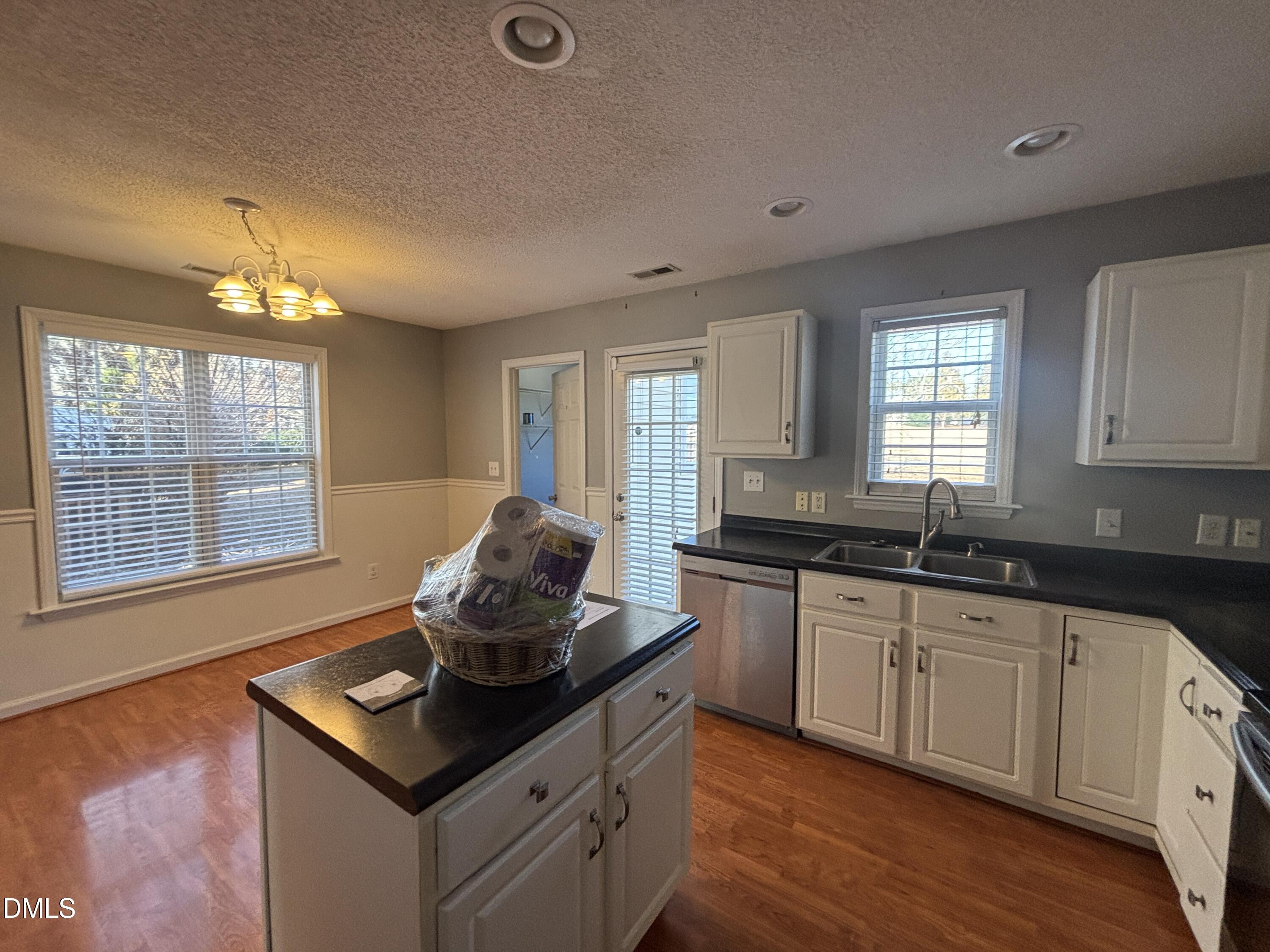 1704 Crag Burn Lane Raleigh, NC 27604 - Photo 15 of 22 a kitchen with granite countertop a sink cabinets and window