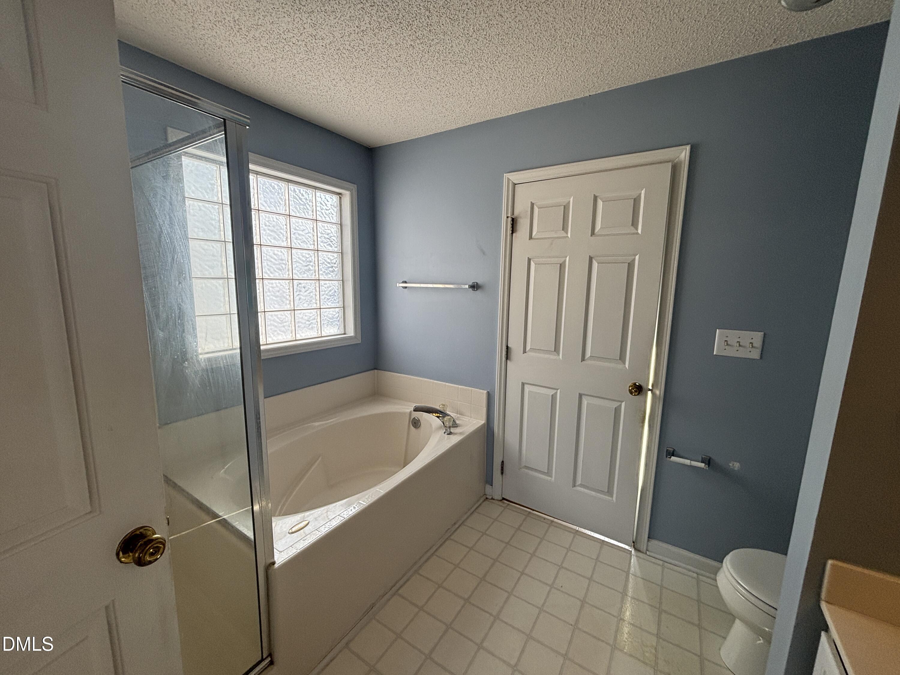 1704 Crag Burn Lane Raleigh, NC 27604 - Photo 18 of 22 a bathroom with a tub a toilet and a sink