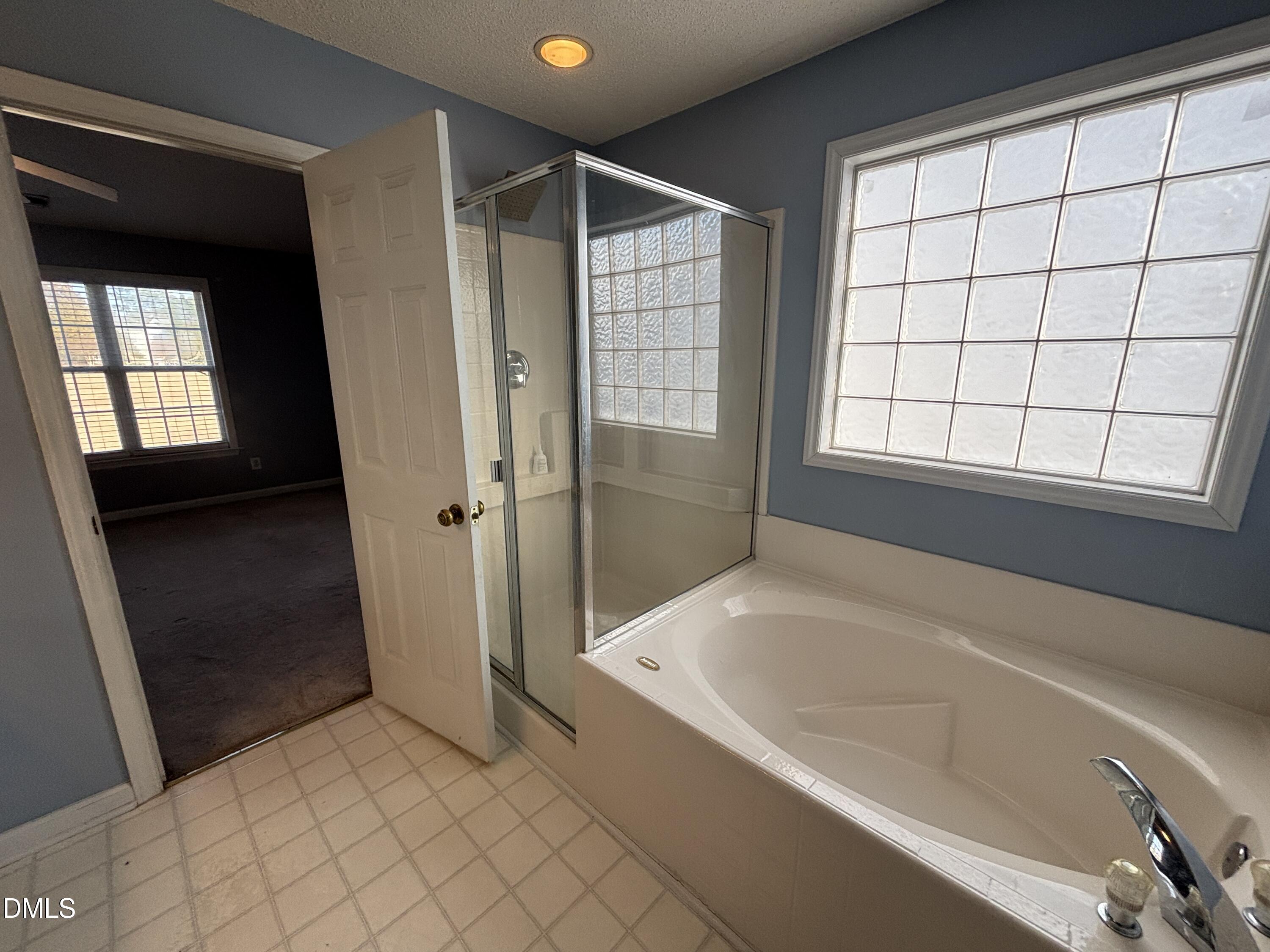 1704 Crag Burn Lane Raleigh, NC 27604 - Photo 20 of 22 a bathroom with a bathtub and a shower