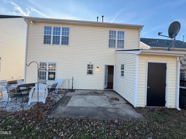 a view of a house with a backyard and a table