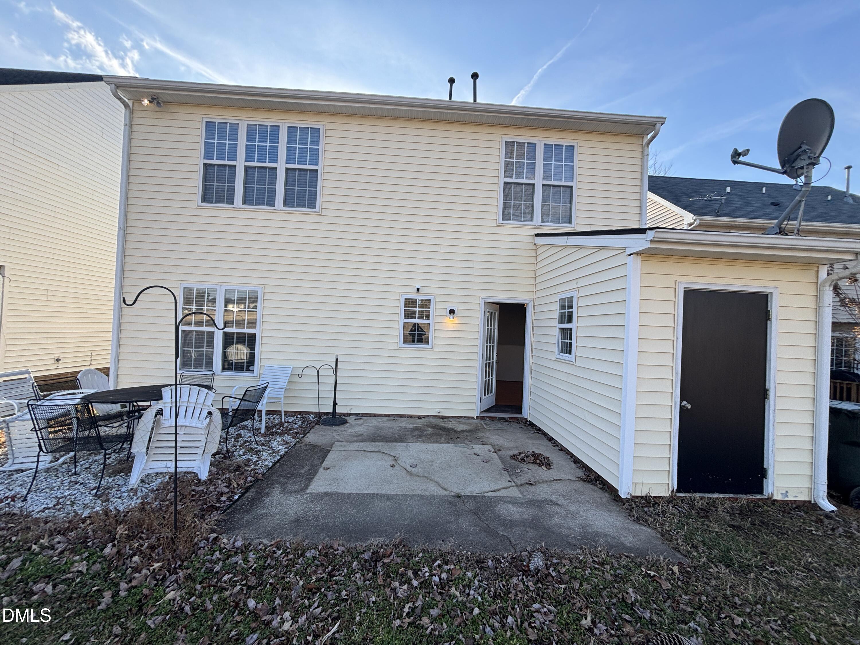1704 Crag Burn Lane Raleigh, NC 27604 - Photo 22 of 22 a view of a house with a backyard and a table