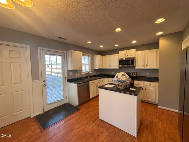 a kitchen with a sink and a stove top oven
