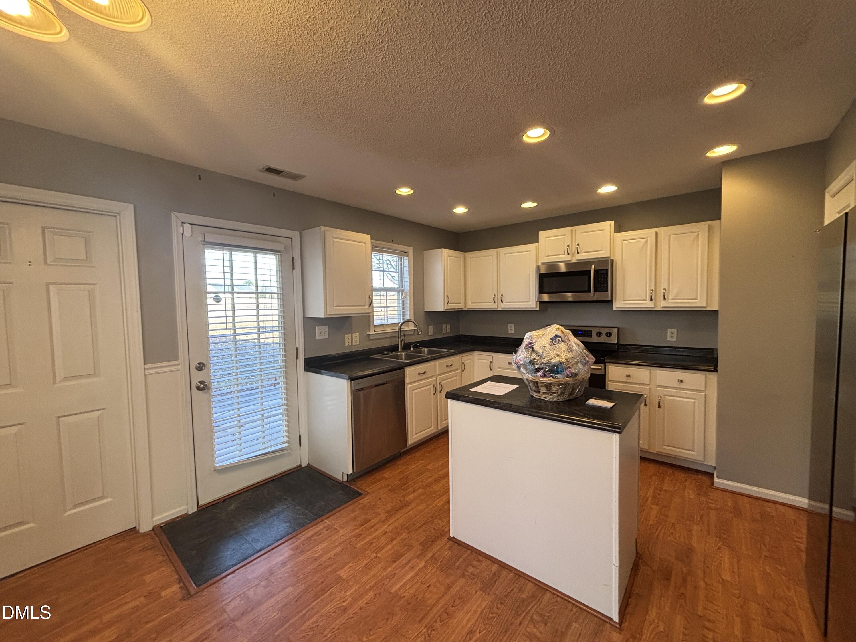 1704 Crag Burn Lane Raleigh, NC 27604 - Photo 3 of 22 a kitchen with a sink and a stove top oven