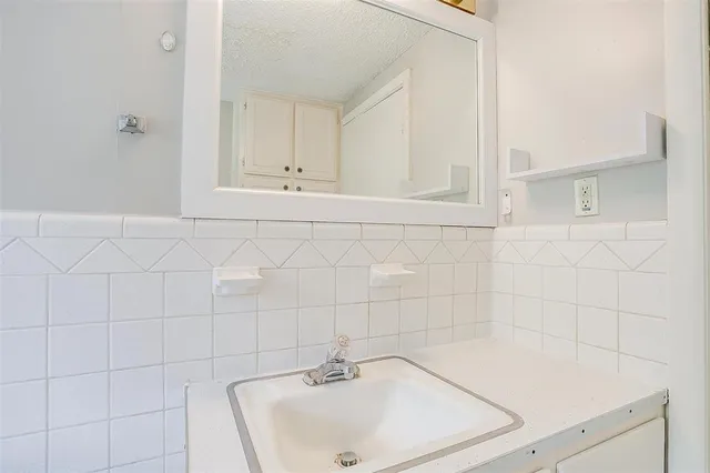 a bathroom with a sink and cabinets