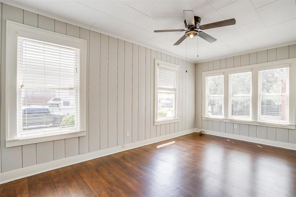 3140 Rogers Avenue, Unit 3142 Fort Worth, TX 76109 - Photo 4 of 13 a view of an empty room with wooden floor and a window