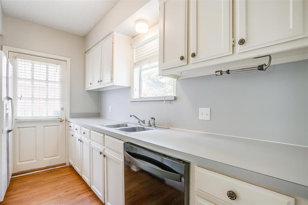 3140 Rogers Avenue, Unit 3142 Fort Worth, TX 76109 - Photo 9 of 13 a kitchen with a sink cabinets and window