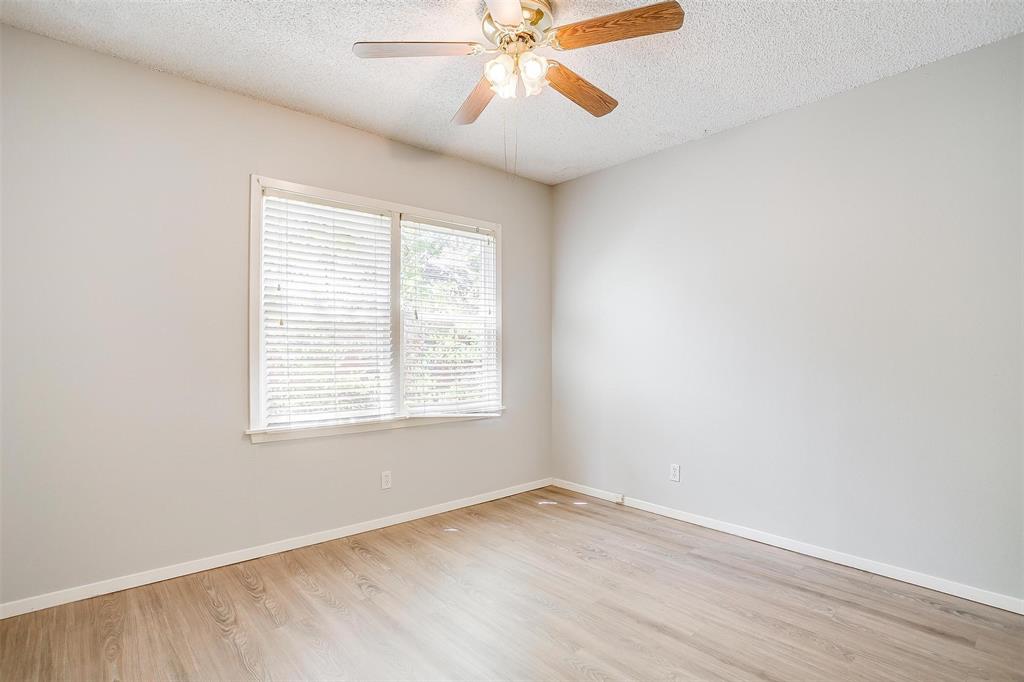 3140 Rogers Avenue, Unit 3142 Fort Worth, TX 76109 - Photo 10 of 13 an empty room with a window and a fan