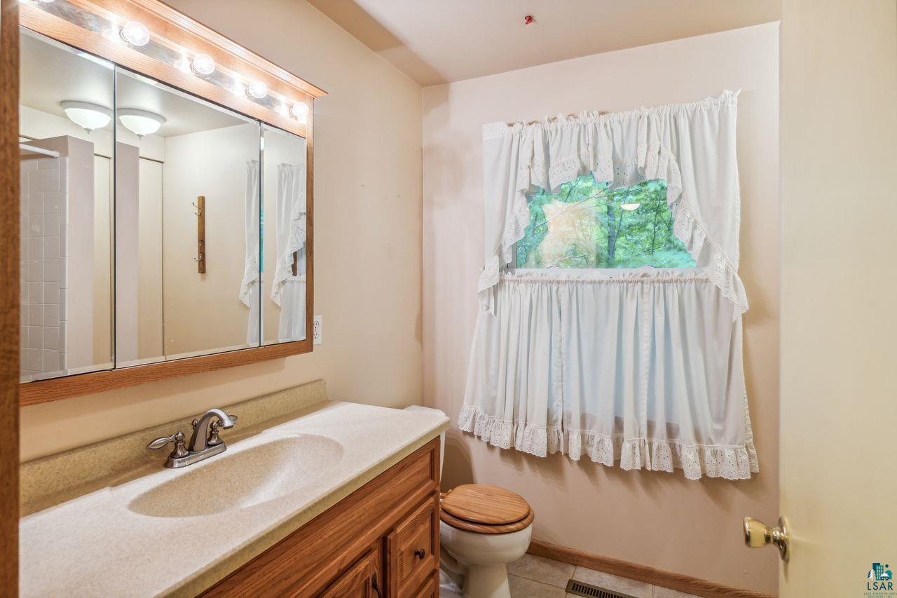 55675 Ashland Bayfield Road Mason, WI 54856 - Photo 10 of 26 Bathroom featuring vanity, toilet, and tile floors