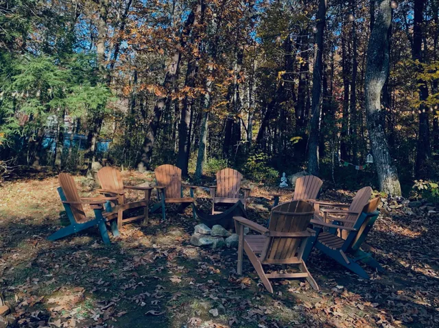 a backyard of a house with table and chairs