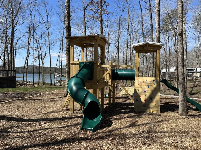 a front view of a house with garden and trees