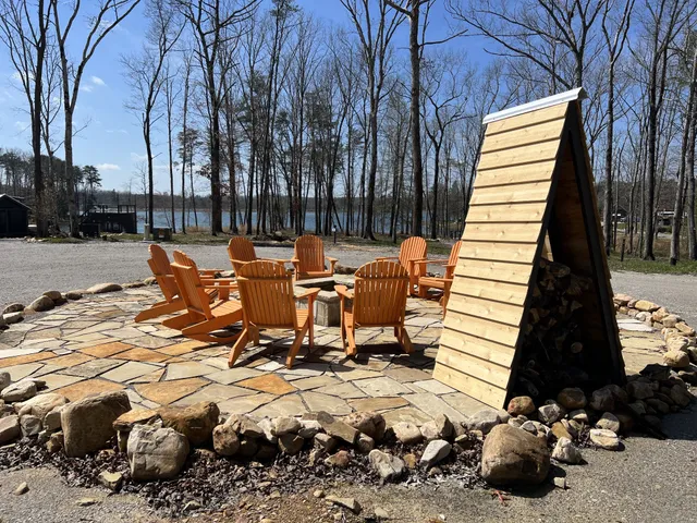 a view of a lake with a yard and large trees