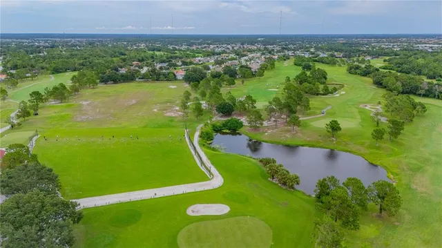 an aerial view of a golf course with swimming pool