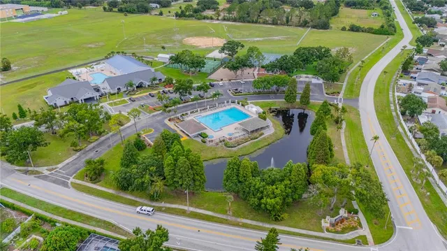 an aerial view of residential houses with outdoor space and street view