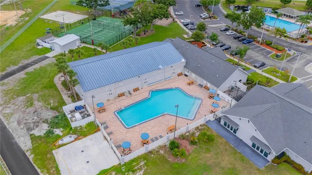 an aerial view of a house with a swimming pool and outdoor space