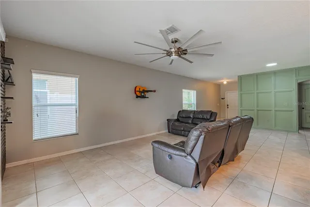 a living room with furniture and kitchen view