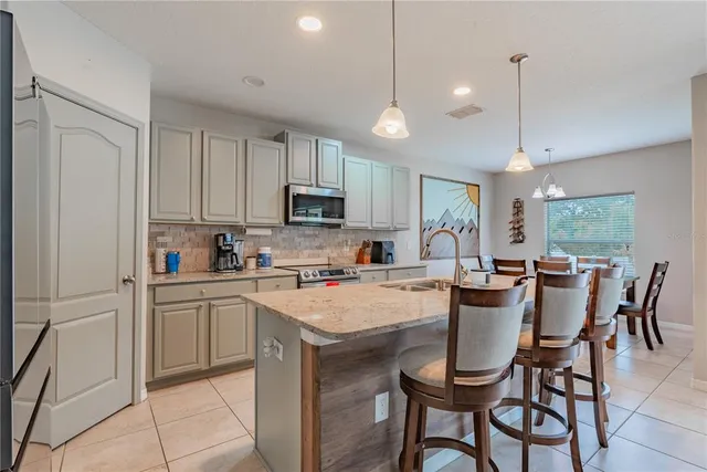 a dining room with furniture a chandelier and window