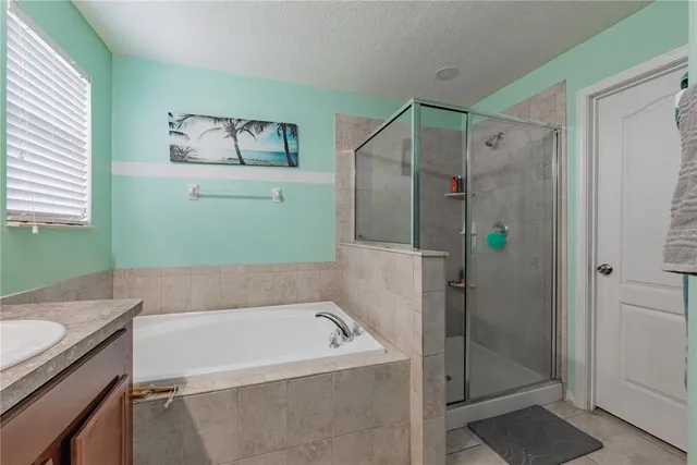 a view of a room with wooden floor and a ceiling fan