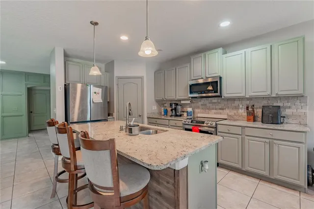 a kitchen with a sink appliances and cabinets