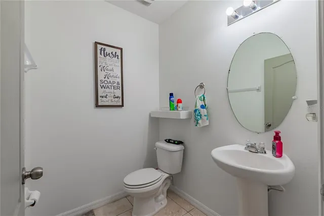 a bathroom with a granite countertop tub sink and mirror