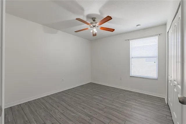 a living room with couches cabinet and window