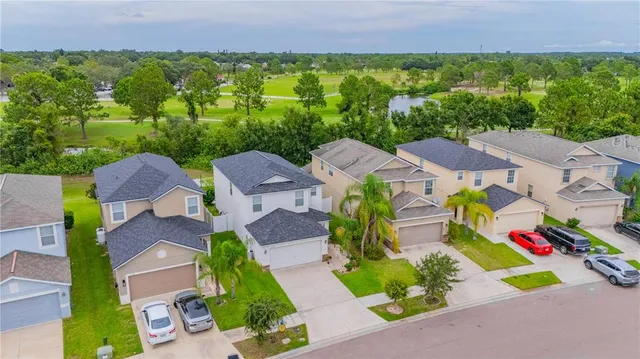 an aerial view of multiple houses with yard