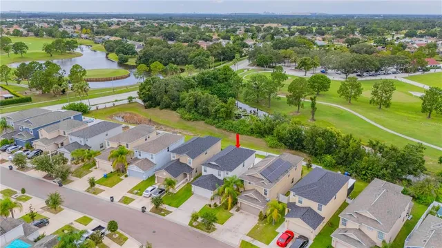 an aerial view of residential houses with outdoor space and street view