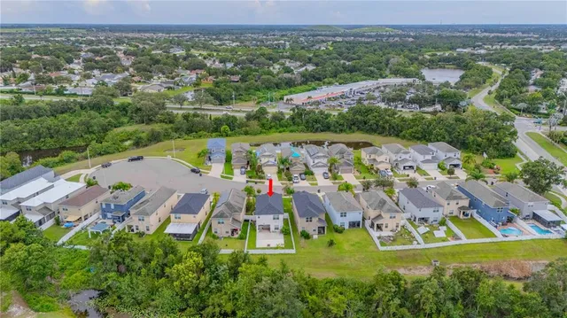 an aerial view of residential house with outdoor space and swimming pool