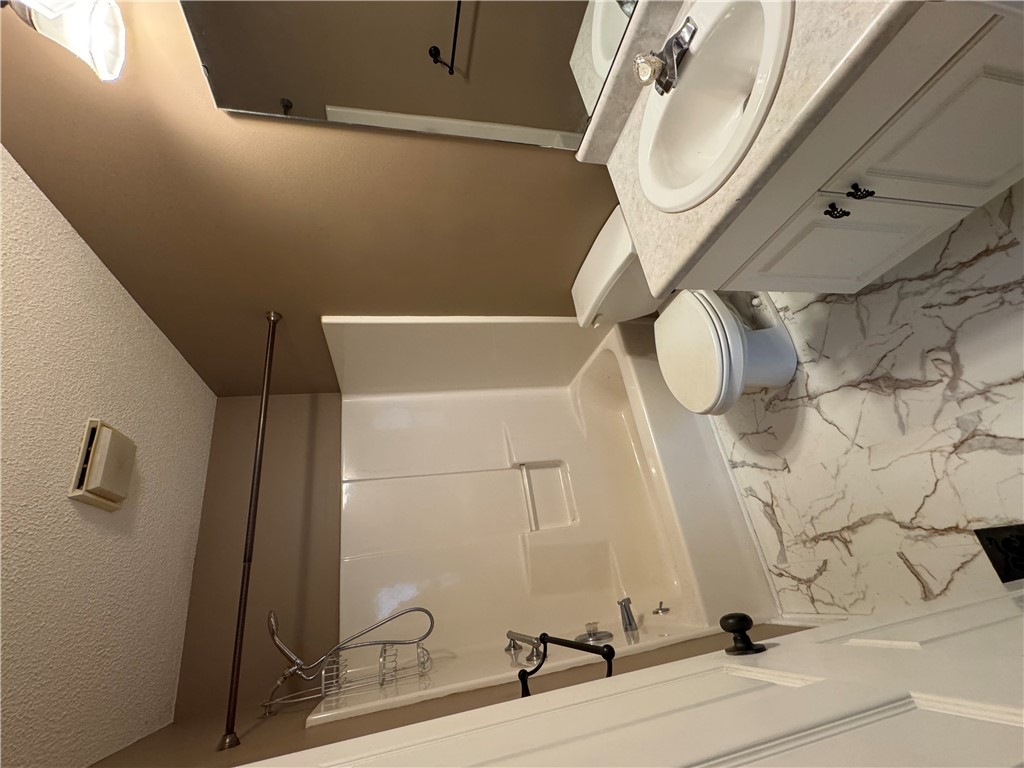 736 Rodgers Road Seneca, SC 29678 - Photo 7 of 10 A compact bathroom featuring a shower-tub combination and vanity, efficiently designed for everyday comfort.