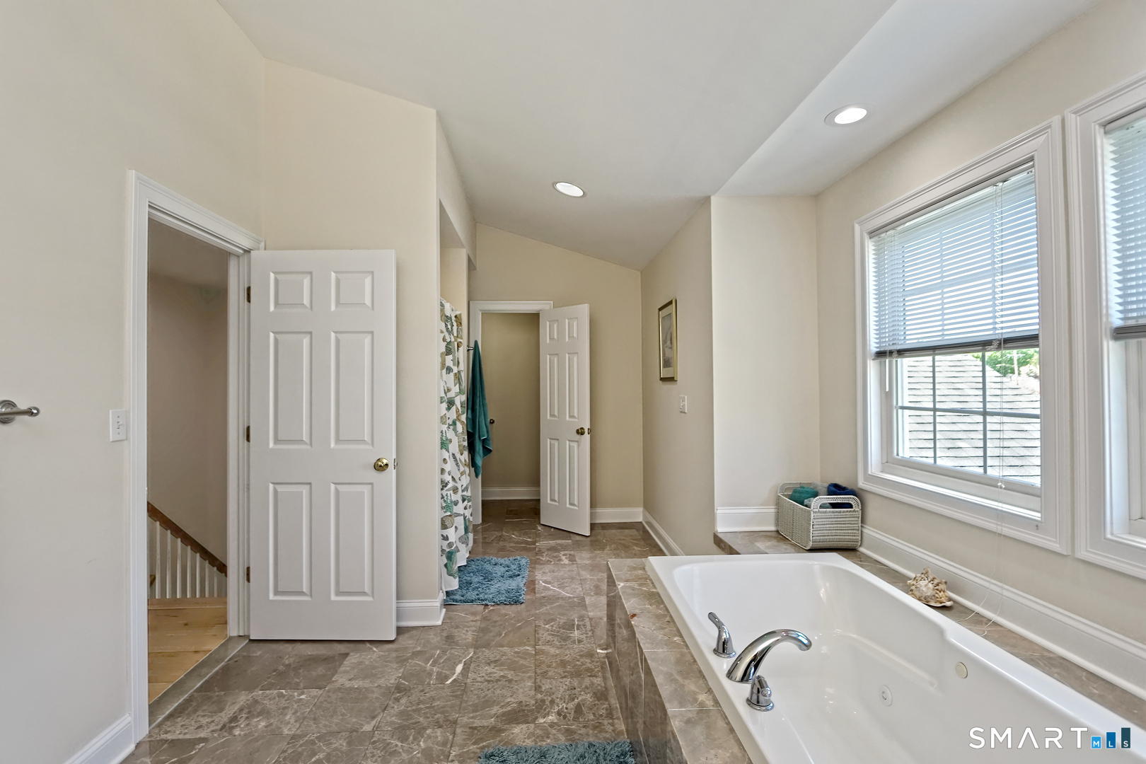102 Lantern Court, Unit 102 Clinton, CT 06413 - Photo 25 of 36 a spacious bathroom with a tub shower and mirror