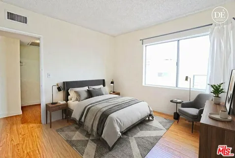 a bedroom with a bed and window