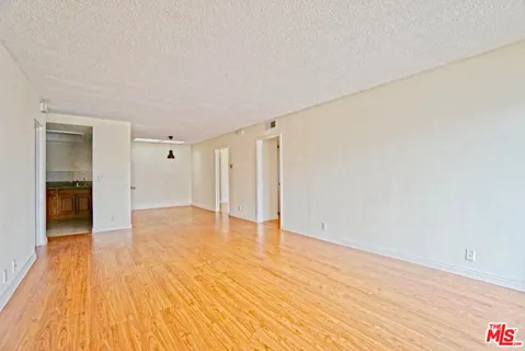 a view of an empty room and wooden floor