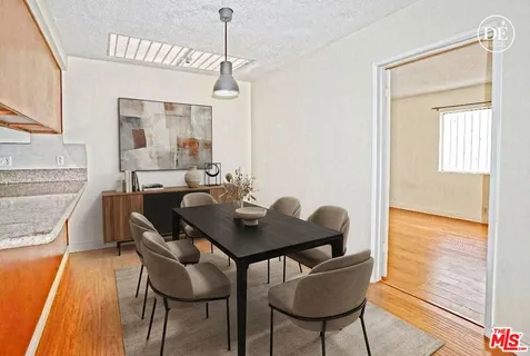 a dining room with furniture and wooden floor