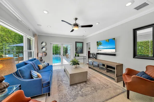 a view of a swimming pool with a patio and a yard