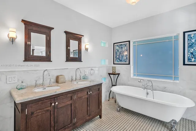 a spacious bathroom with double sink and a mirror