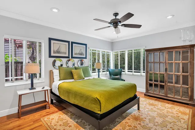 a blue bed sitting in a bedroom next to a window
