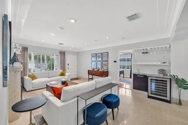 a living room with furniture fireplace and a window