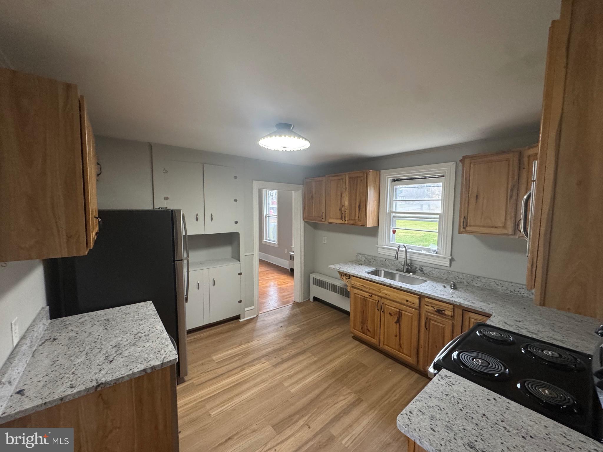 801 East Moler Avenue Martinsburg, WV 25404 - Photo 7 of 19 a kitchen with granite countertop a sink stove and refrigerator