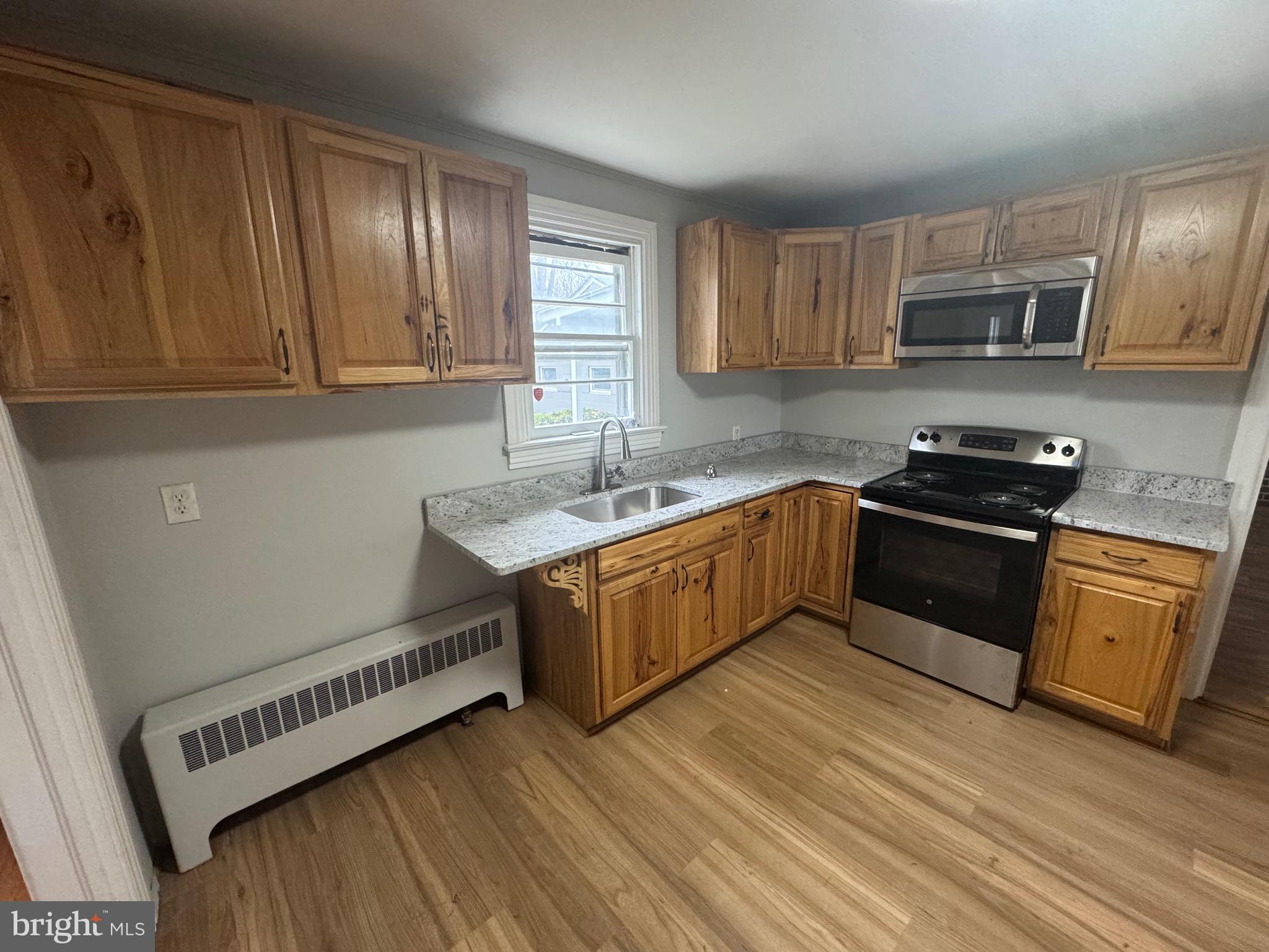 801 East Moler Avenue Martinsburg, WV 25404 - Photo 8 of 19 a kitchen with stainless steel appliances granite countertop a sink a stove and cabinets
