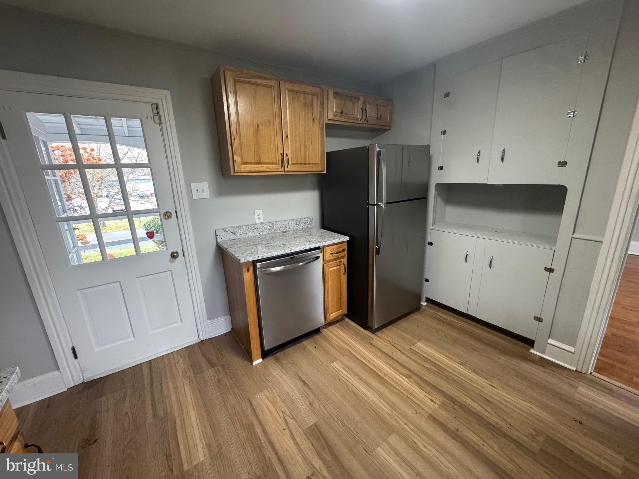 801 East Moler Avenue Martinsburg, WV 25404 - Photo 9 of 19 a kitchen with a refrigerator stove and white cabinets