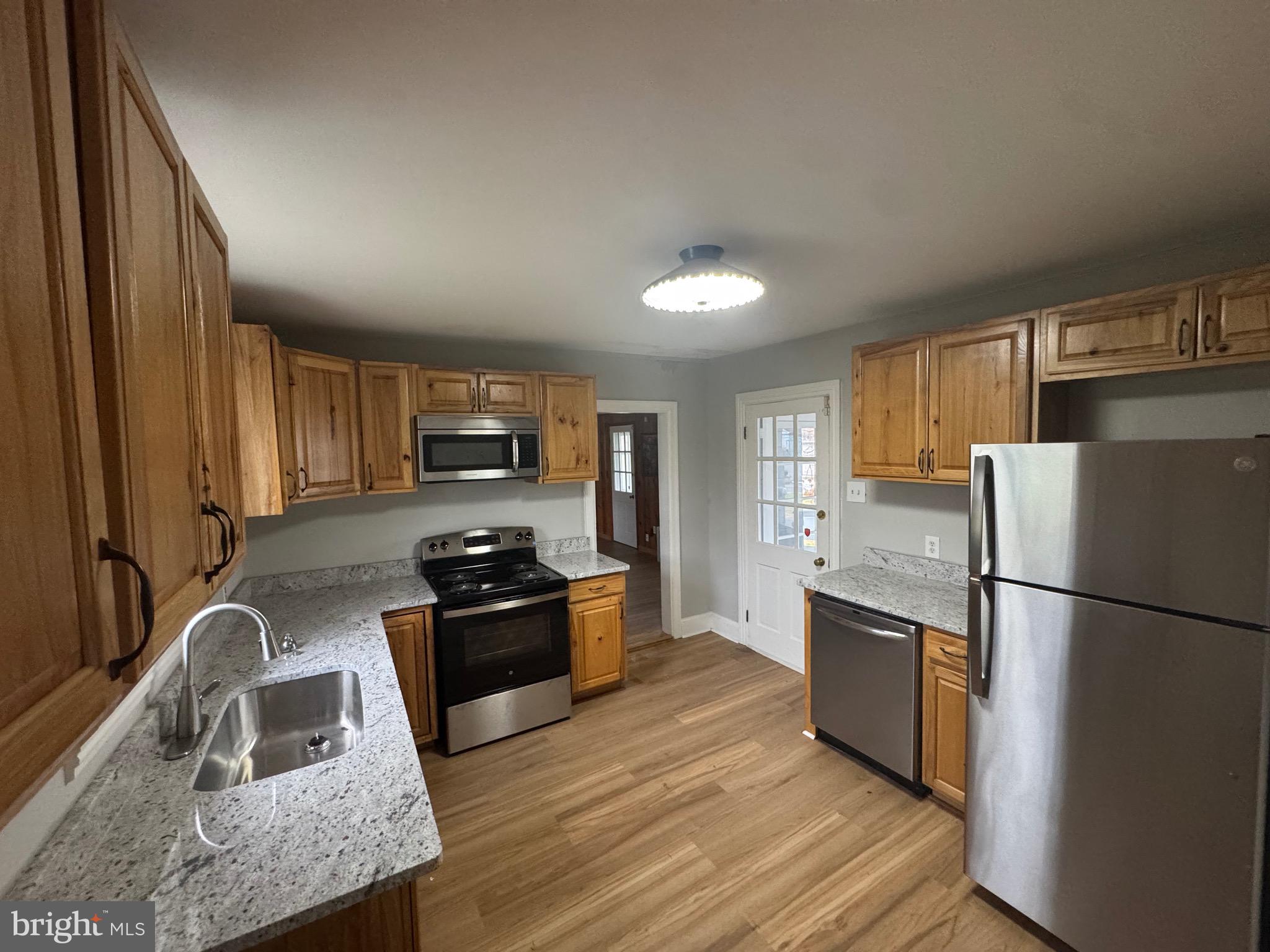 801 East Moler Avenue Martinsburg, WV 25404 - Photo 10 of 19 a kitchen with granite countertop a refrigerator stove and sink