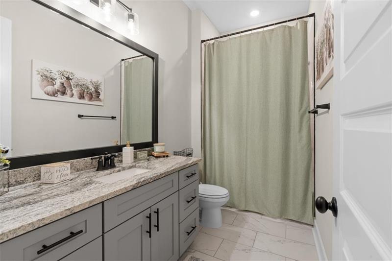 283 London Road Ball Ground, GA 30107 - Photo 39 of 73 a bathroom with a granite countertop sink toilet and shower