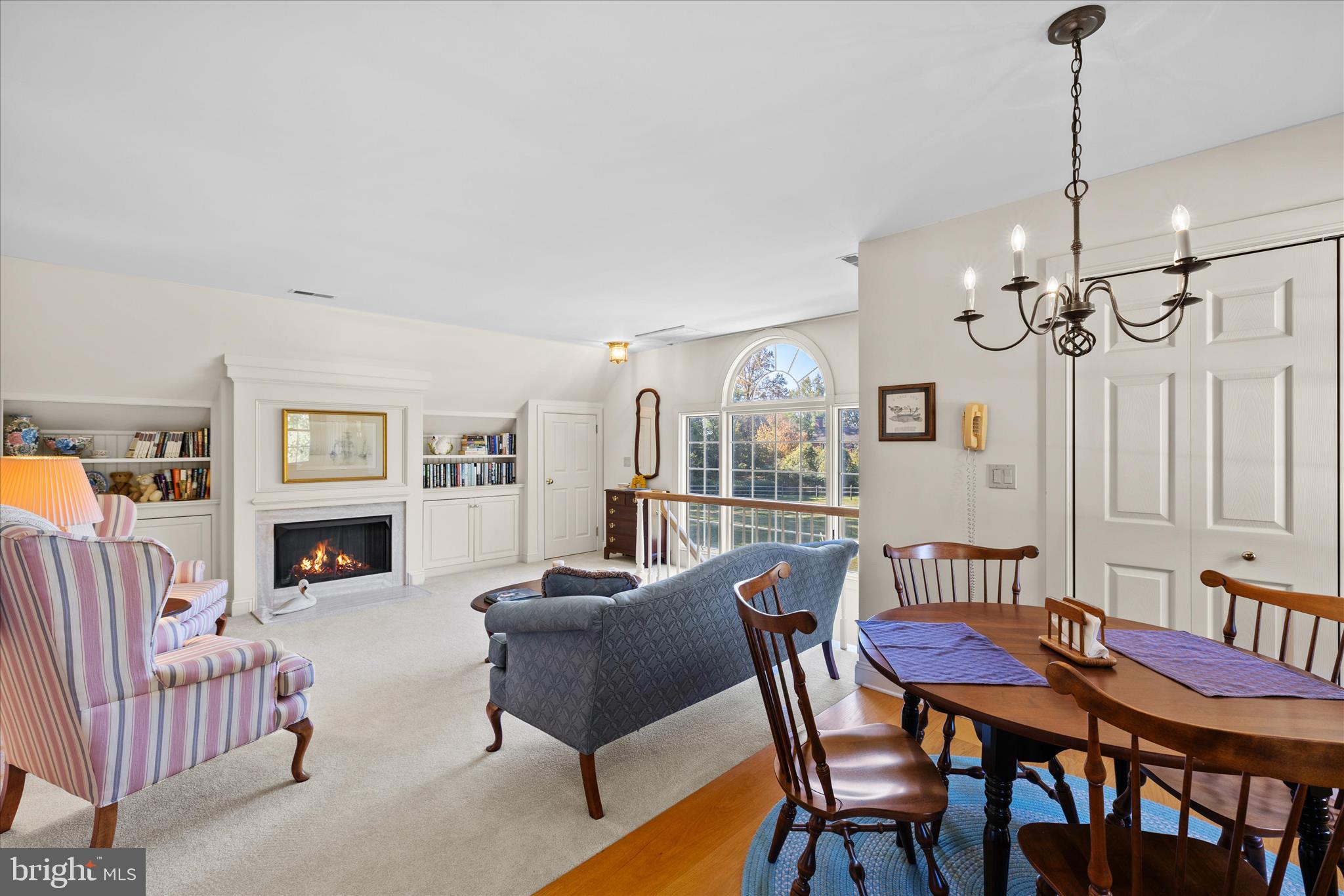 27473 Westpoint Road Easton, MD 21601 - Photo 50 of 58 a view of a dining room with furniture a fireplace and chandelier