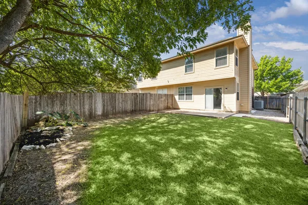 a backyard of a house with table and chairs