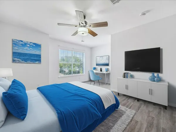 a bedroom with a bed and a flat screen tv