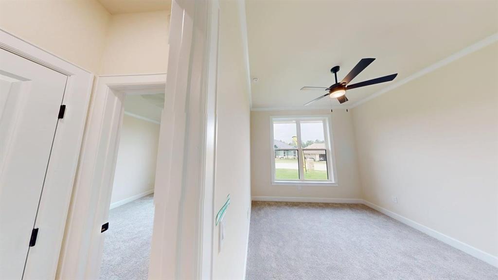 2509 Windmill Lane Longview, TX 75601 - Photo 12 of 35 Room featuring carpet floors and a ceiling fan